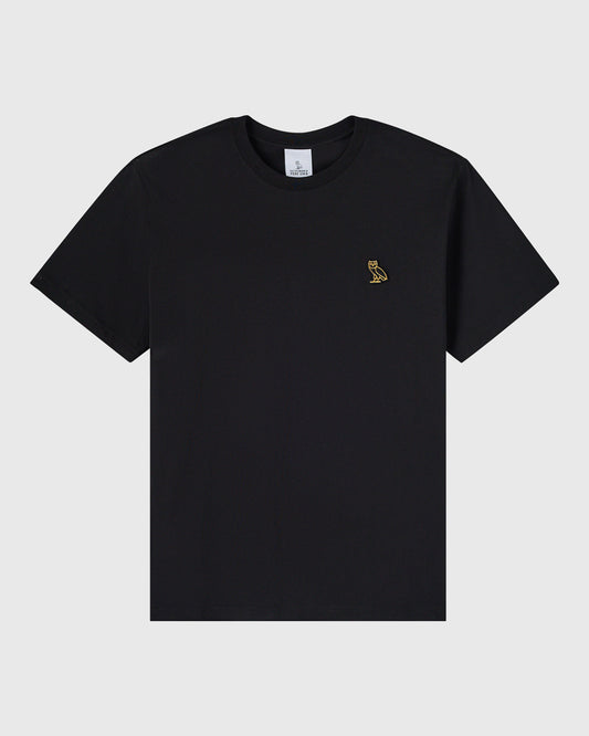 Black crewneck t-shirt with small gold owl emblem on chest.
