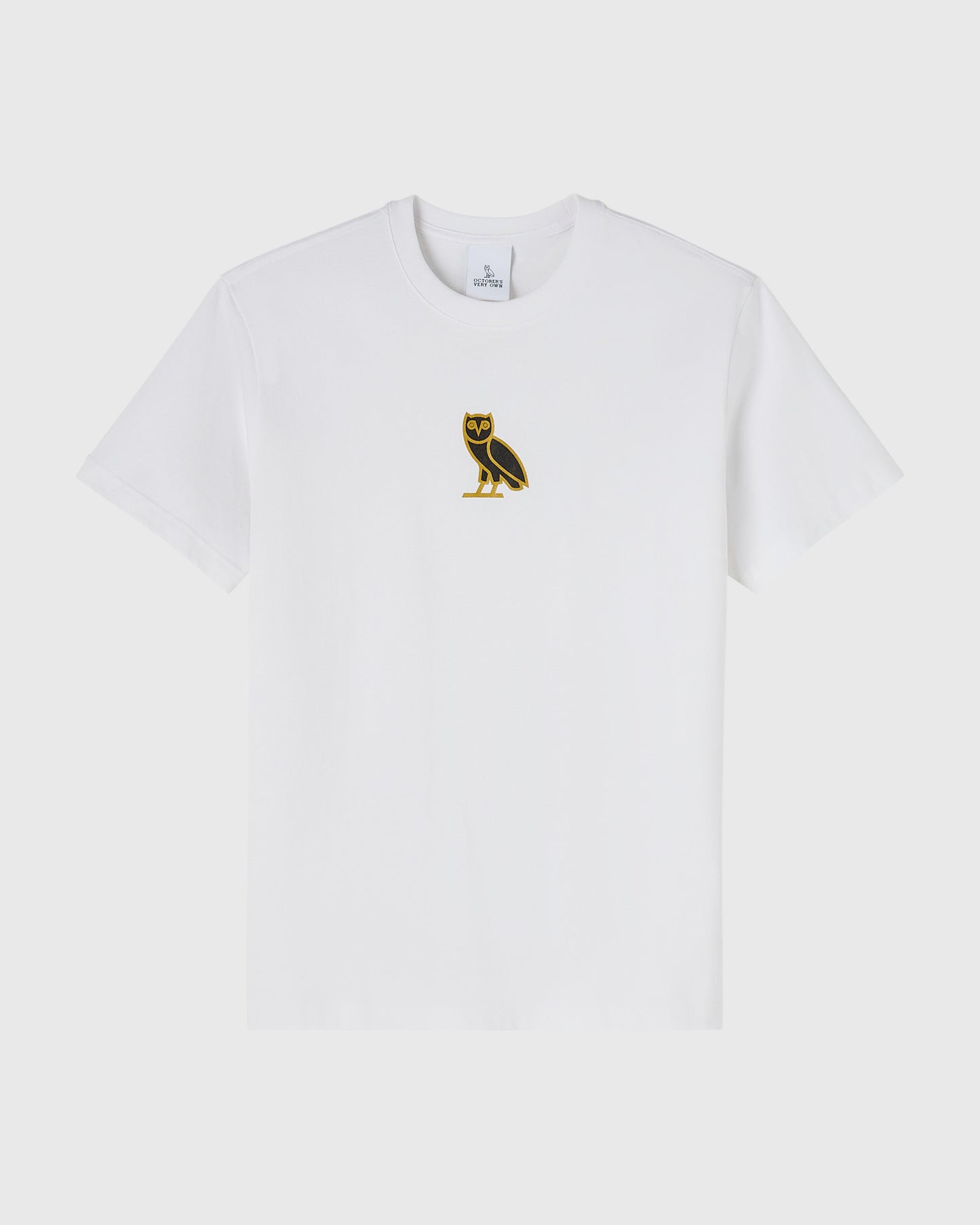 White short-sleeve t-shirt with small gold and black owl emblem on chest.