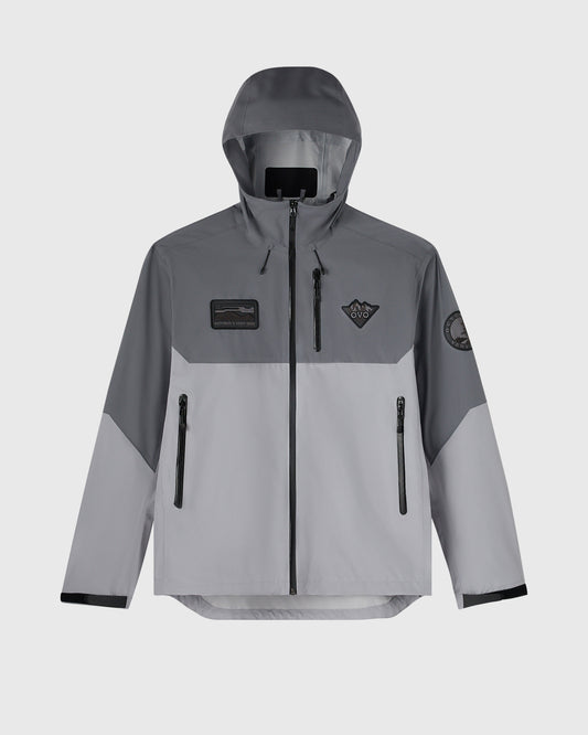Grey and light grey hiking shell jacket with hood, front zip closure, chest badges, and multiple pockets.