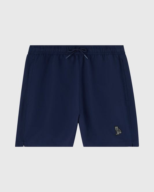 Navy swim shorts with drawstring waist, side pockets, and small embroidered logo on thigh.
