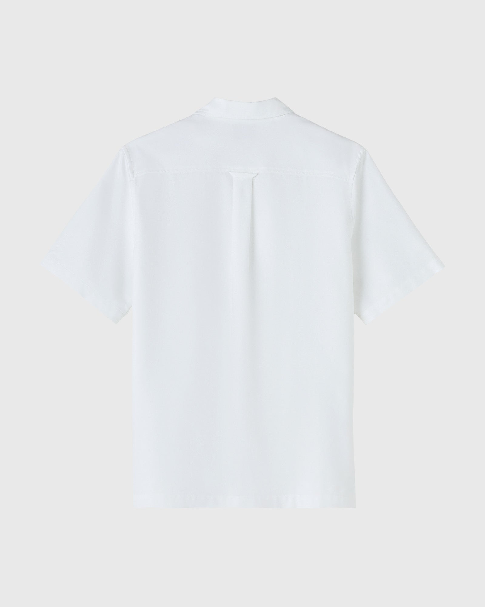 White short-sleeve camp shirt with button front and chest pocket, displayed flat against neutral background.