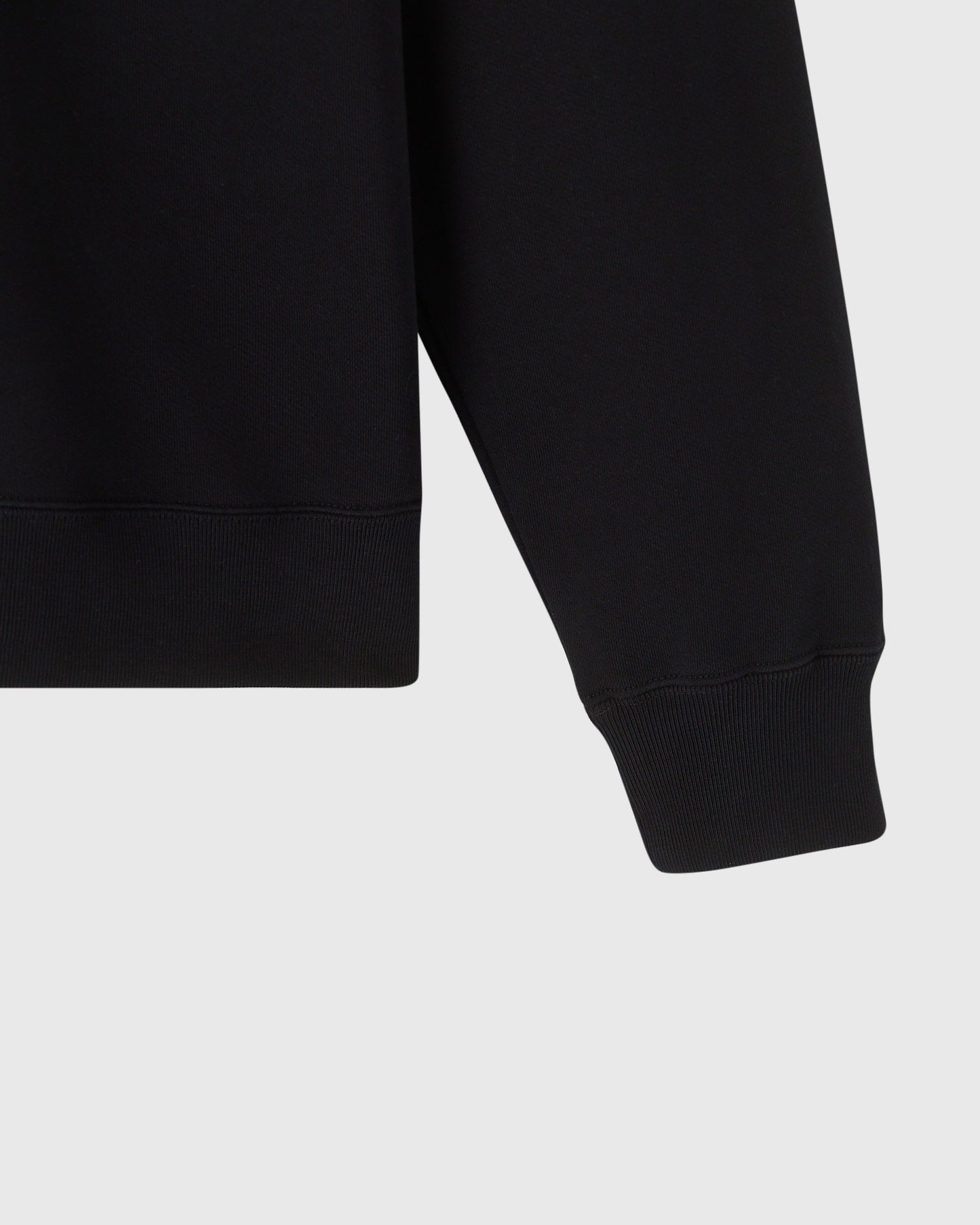 Black sweatshirt with quarter-zip neckline and ribbed cuffs and hem.