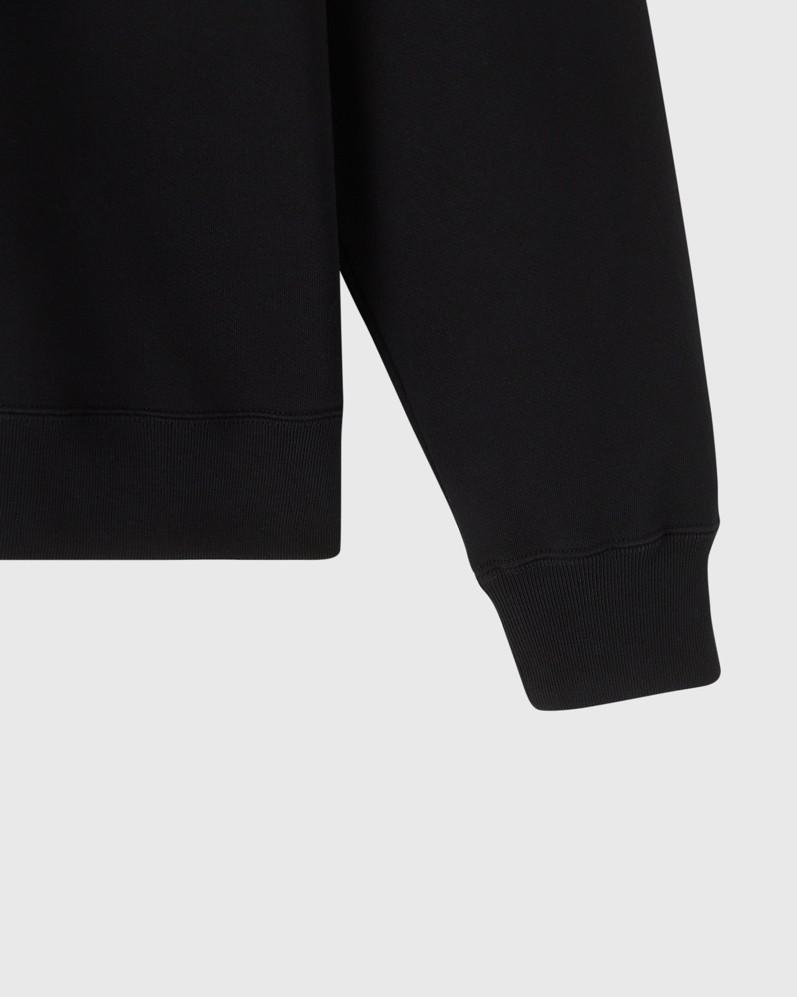 Black sweatshirt with quarter-zip neckline and ribbed cuffs and hem.