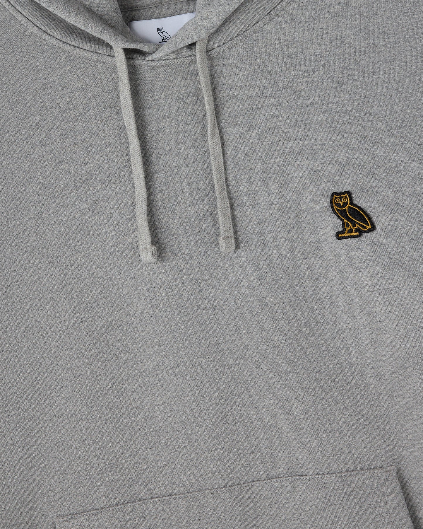 Heather grey pullover hoodie with drawstring and small owl embroidered logo on chest.