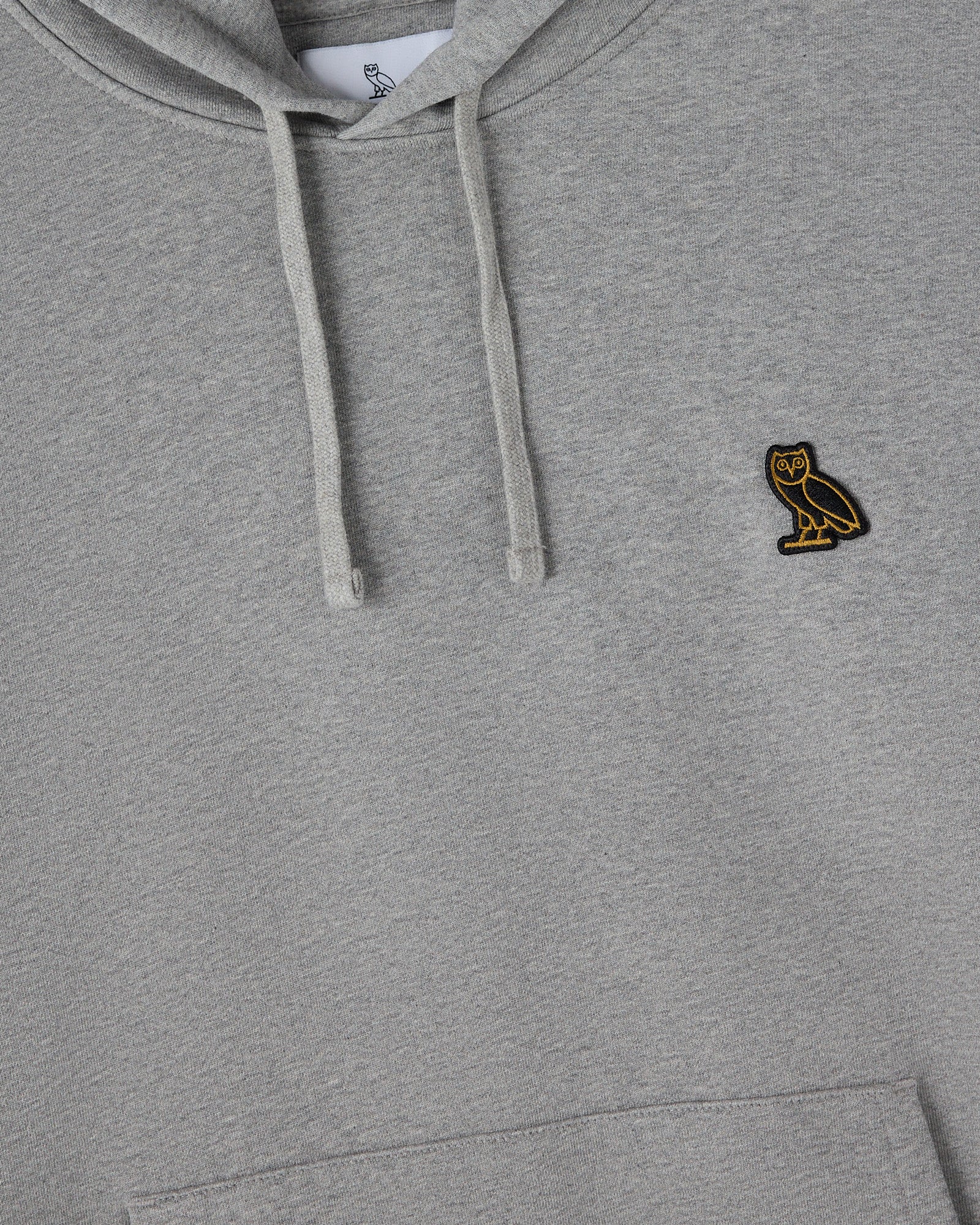 Heather grey pullover hoodie with drawstring and small owl embroidered logo on chest.