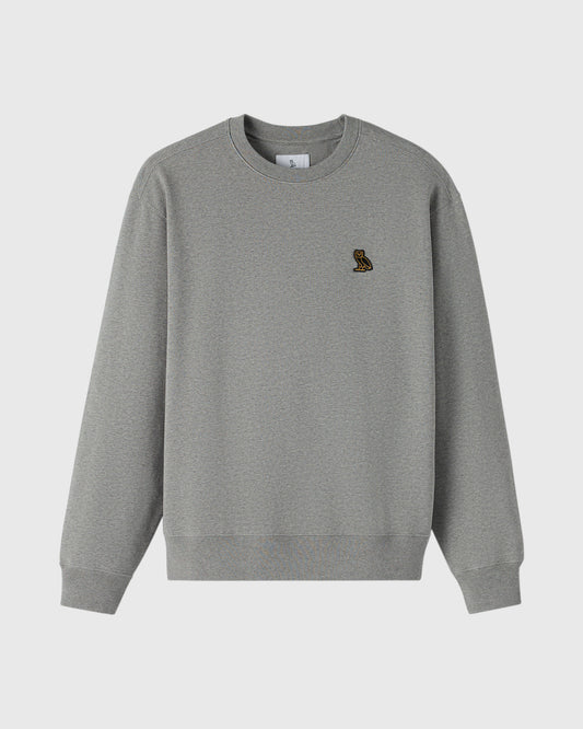 Heather grey crewneck sweatshirt with small embroidered owl logo on chest.