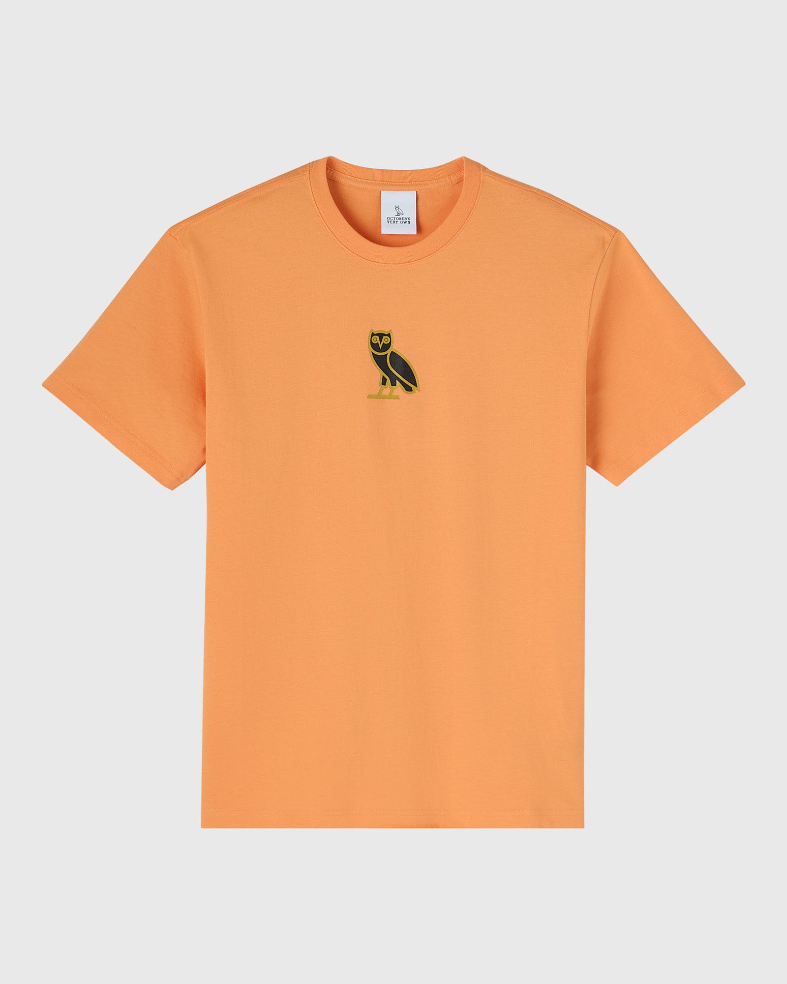 Apricot crewneck t-shirt with small black owl embroidery on chest.