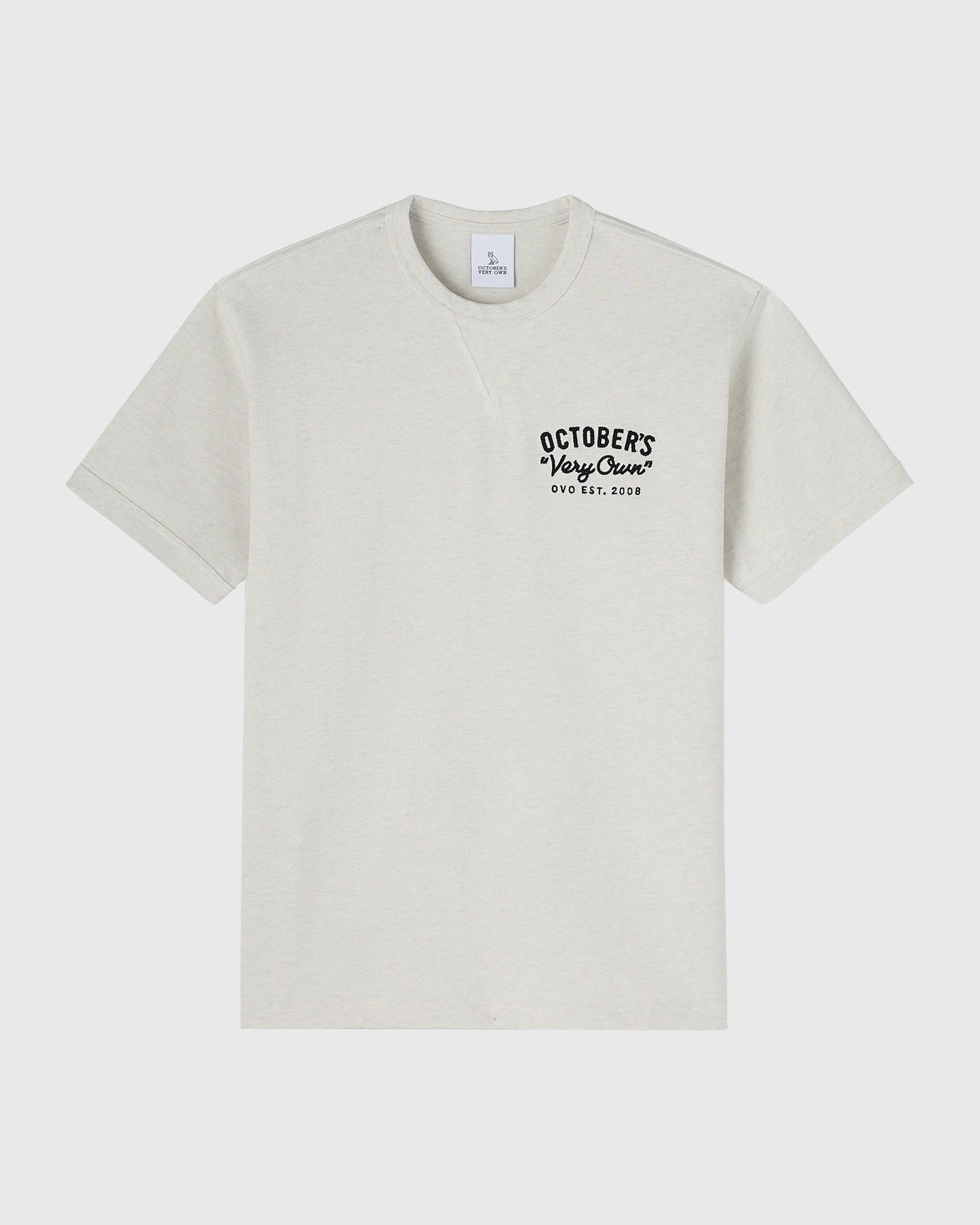 Cream short-sleeve t-shirt with black "October's Very Own" text and "OVO EST. 2008" printed on chest.