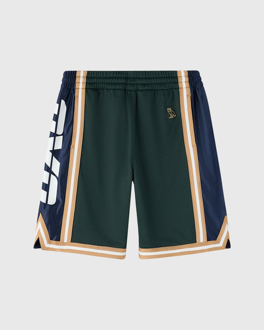 Midnight green basketball shorts with navy and tan side panels, white and tan striping, and small gold embroidered logo on ch