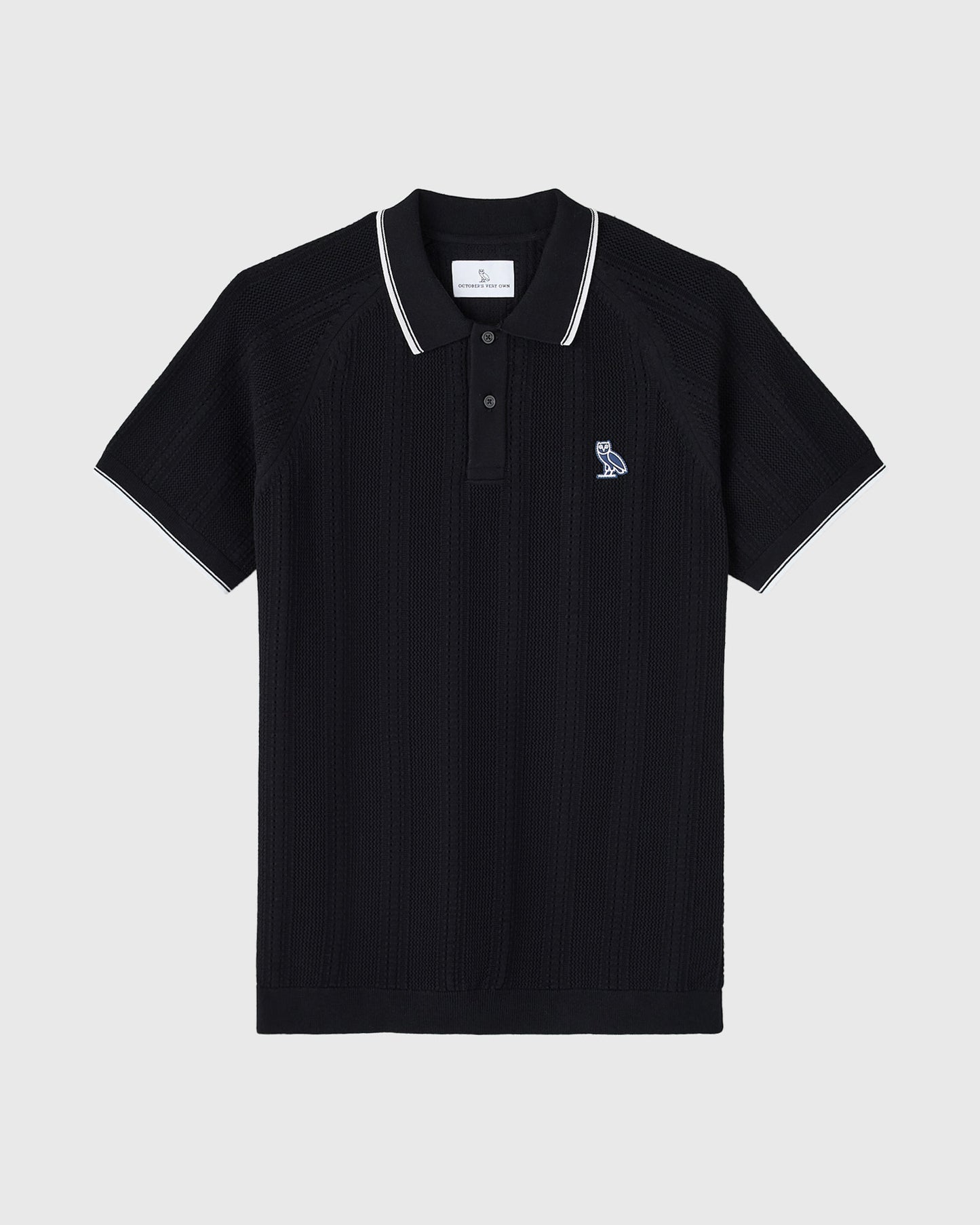 Black open knit polo shirt with white tipping on collar and sleeves, featuring small embroidered logo on chest.