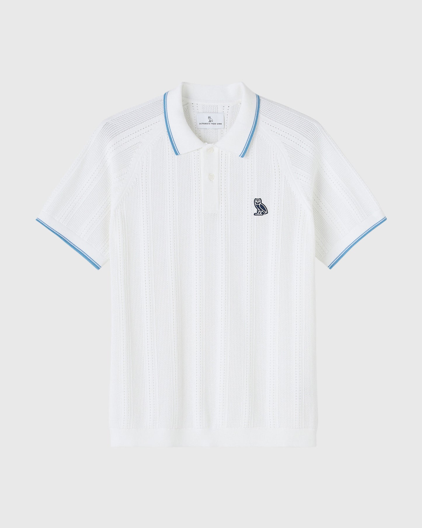 White open knit polo shirt with blue trim on collar and sleeves, small owl emblem on chest.