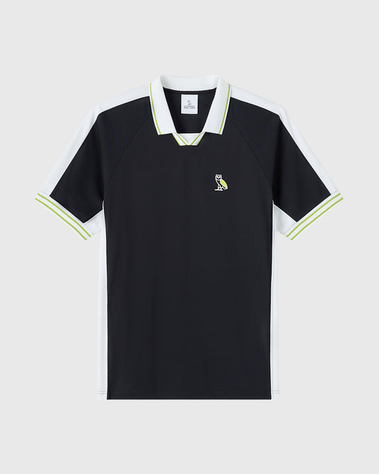 Black piqué polo shirt with white collar and lime-green trim, white side panels, and small owl emblem on chest.