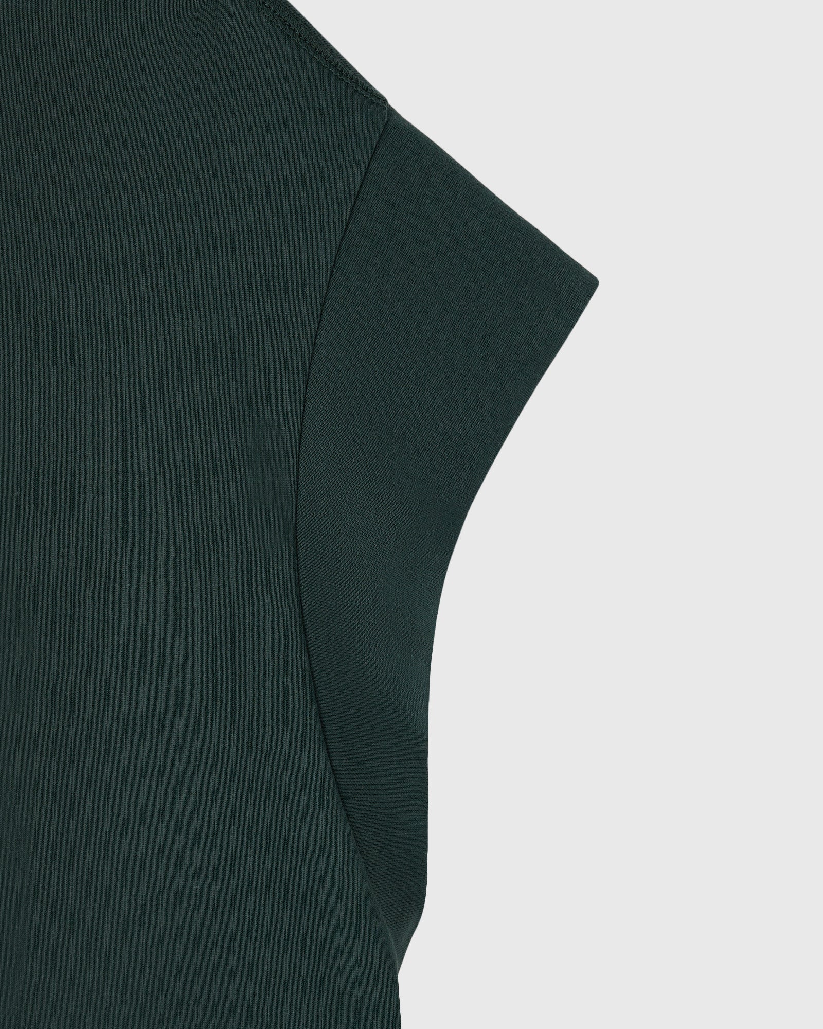 Midnight green muscle tee with ribbed texture and short sleeves, shown in close-up detail.