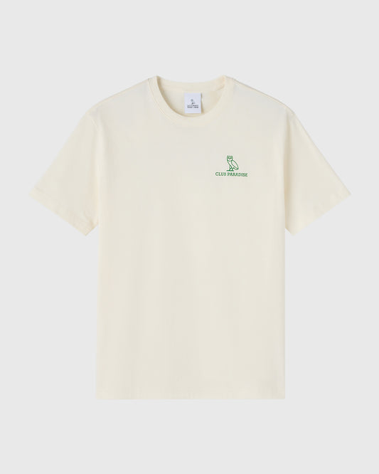 Cream-colored short-sleeve t-shirt with green owl logo and "Club Paradise" text on chest.