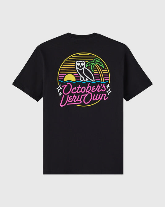 Black t-shirt with neon-style graphic featuring an owl, sun, and "October's Very Own" text in yellow, pink, and green.
