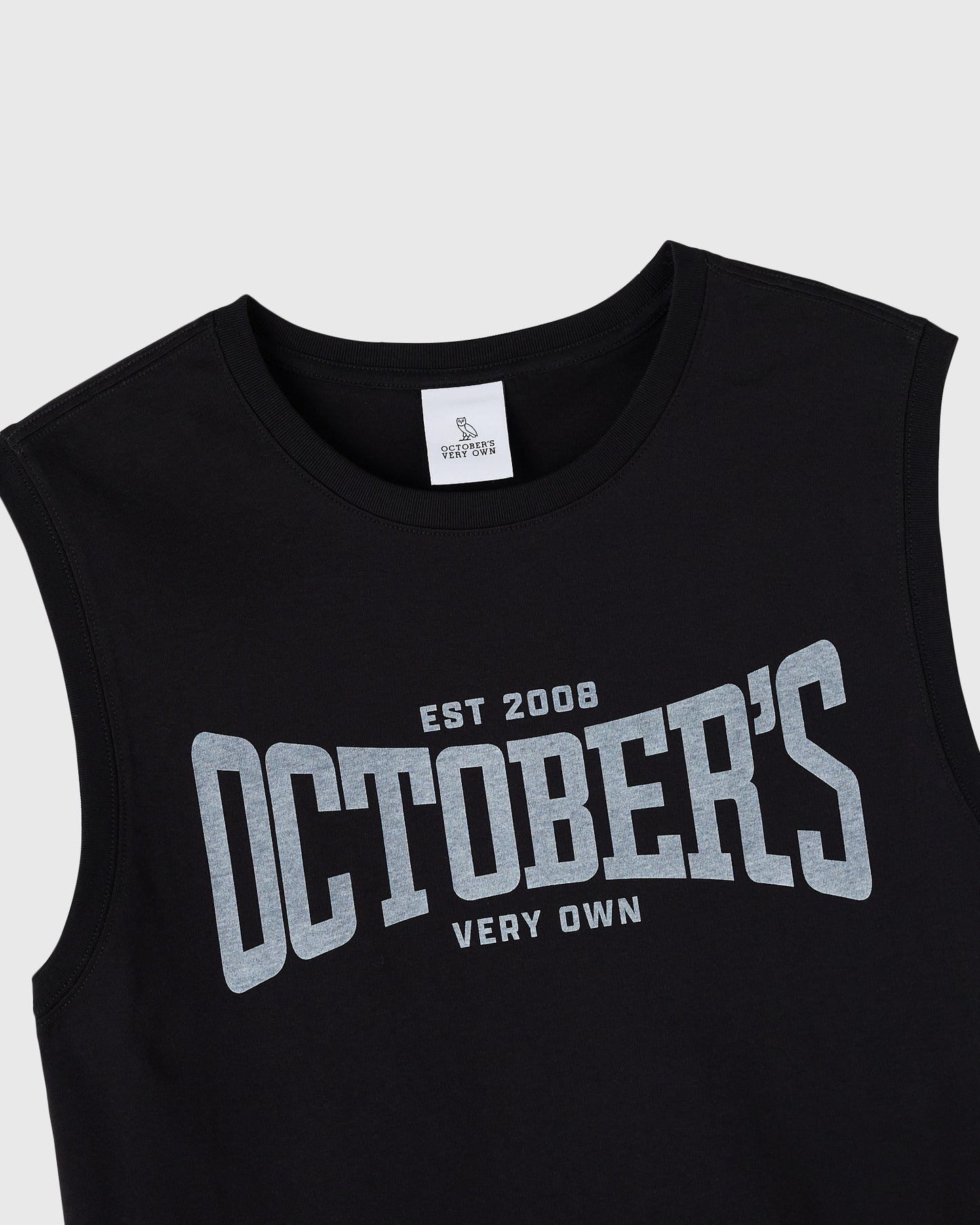 Black sleeveless tank top with gray text reading "EST 2008 OCTOBERS VERY OWN" across the chest.
