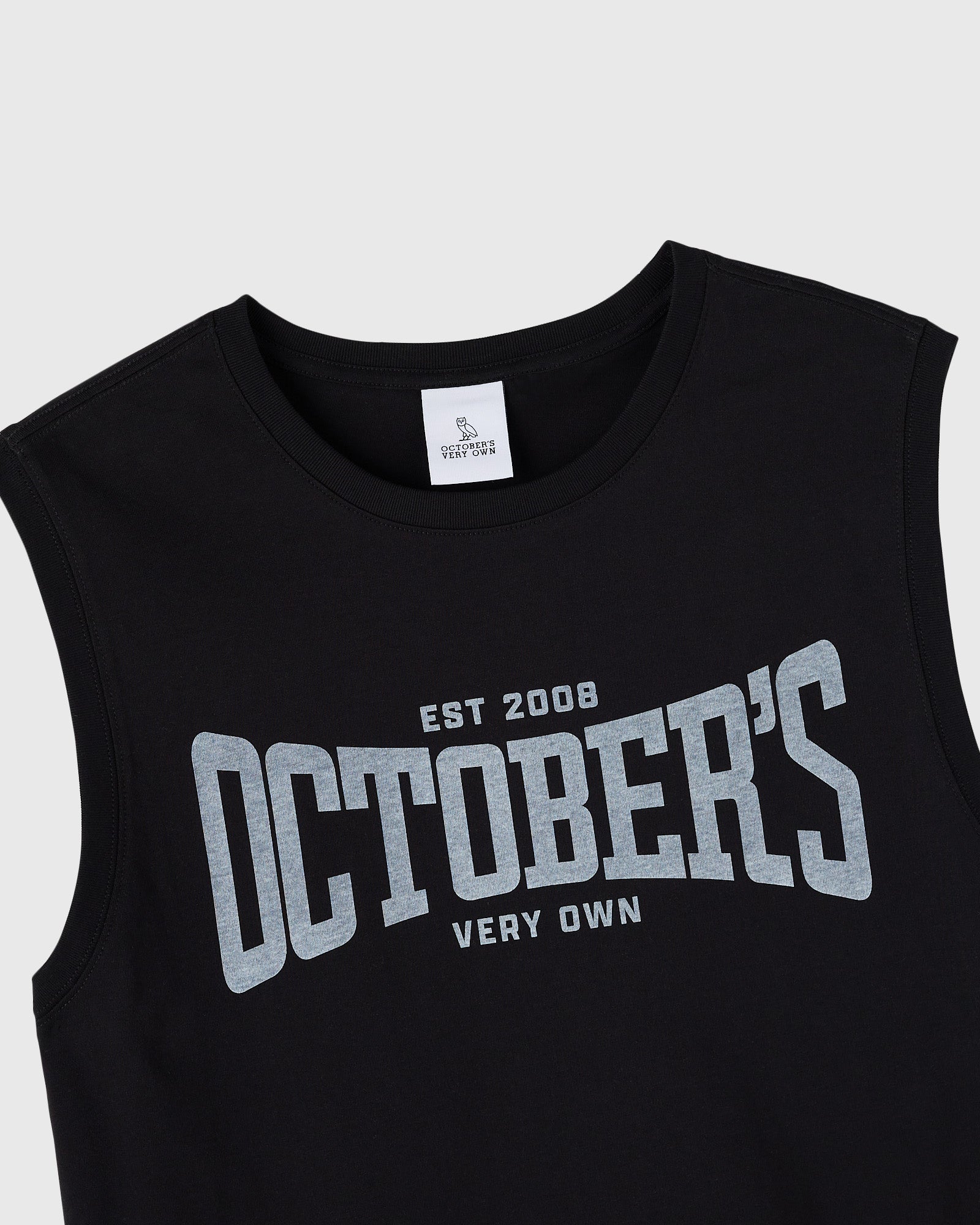 Black sleeveless tank top with gray text reading "EST 2008 OCTOBERS VERY OWN" across the chest.