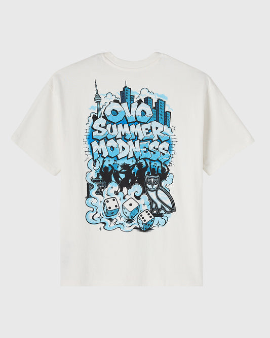 Off-white short-sleeve tee with blue and black graphic print featuring stylized text, city skyline, and gaming elements.
