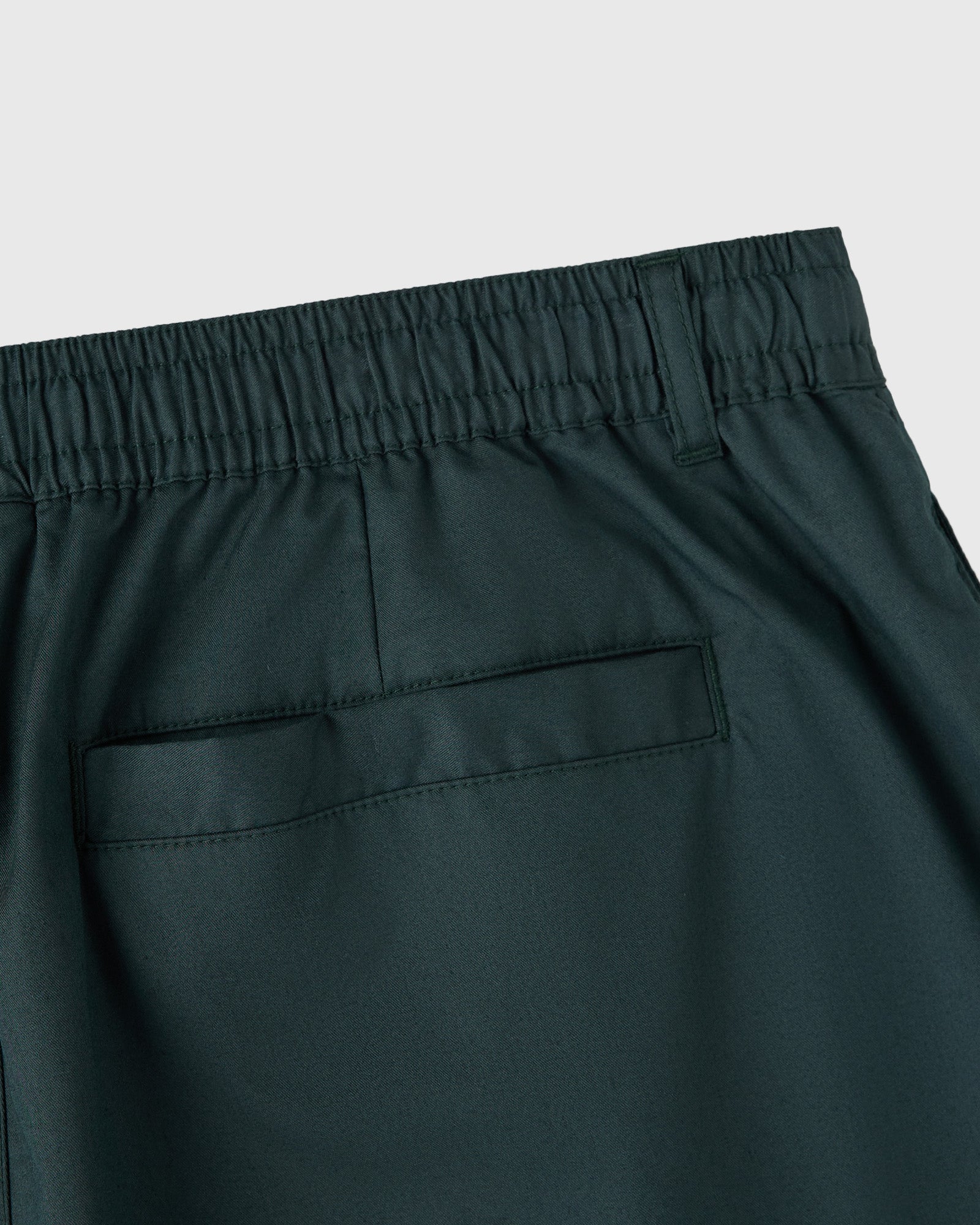 Midnight green shorts with elasticized waistband and back patch pockets.