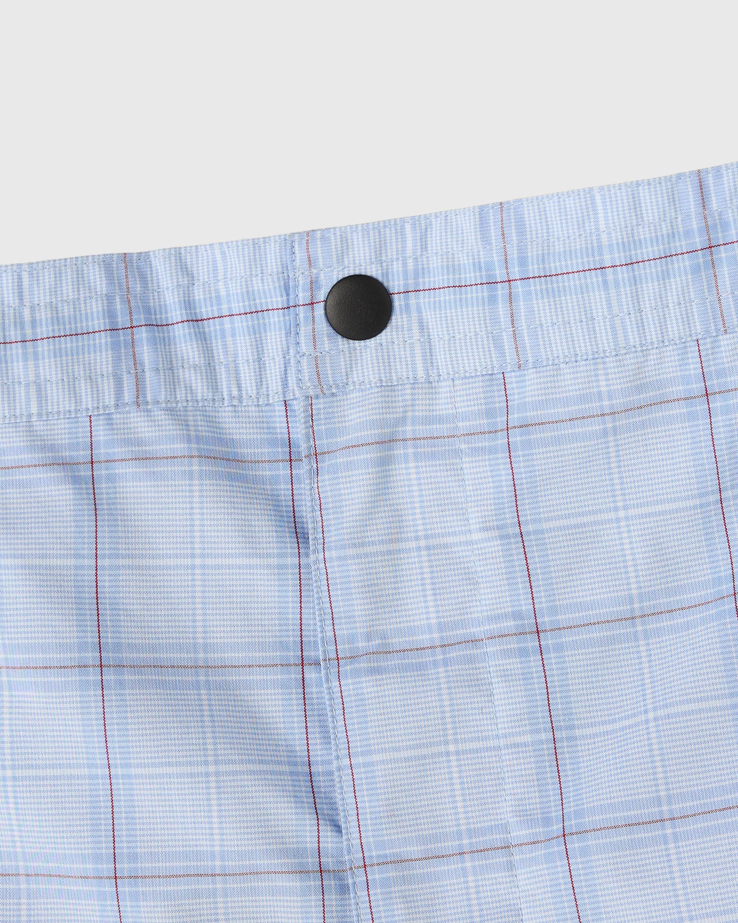 Light blue camp short with red and white grid pattern, black button waistband, and vertical seam details.