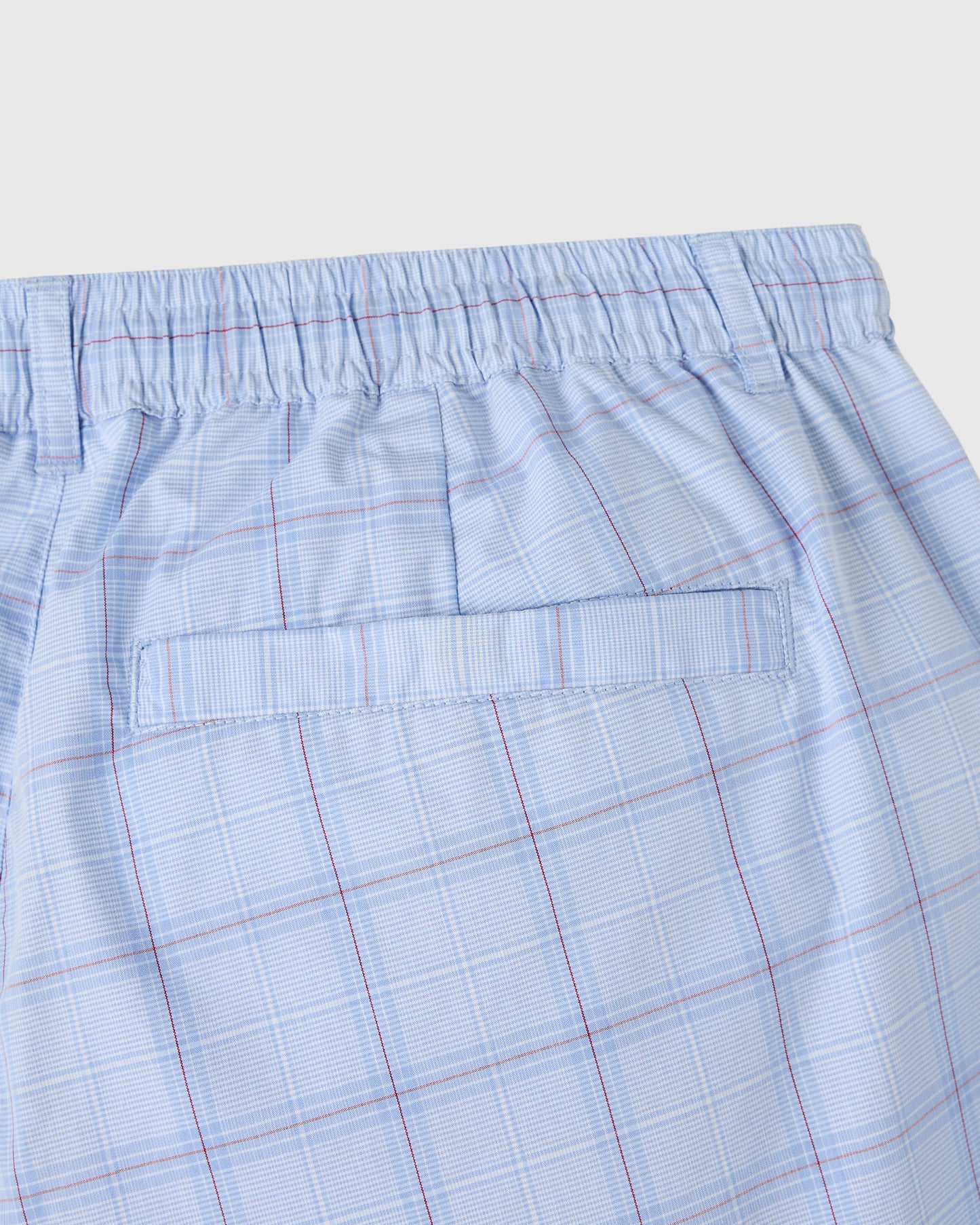 Light blue shorts with red and white plaid pattern, elastic waistband, and front pocket detail.