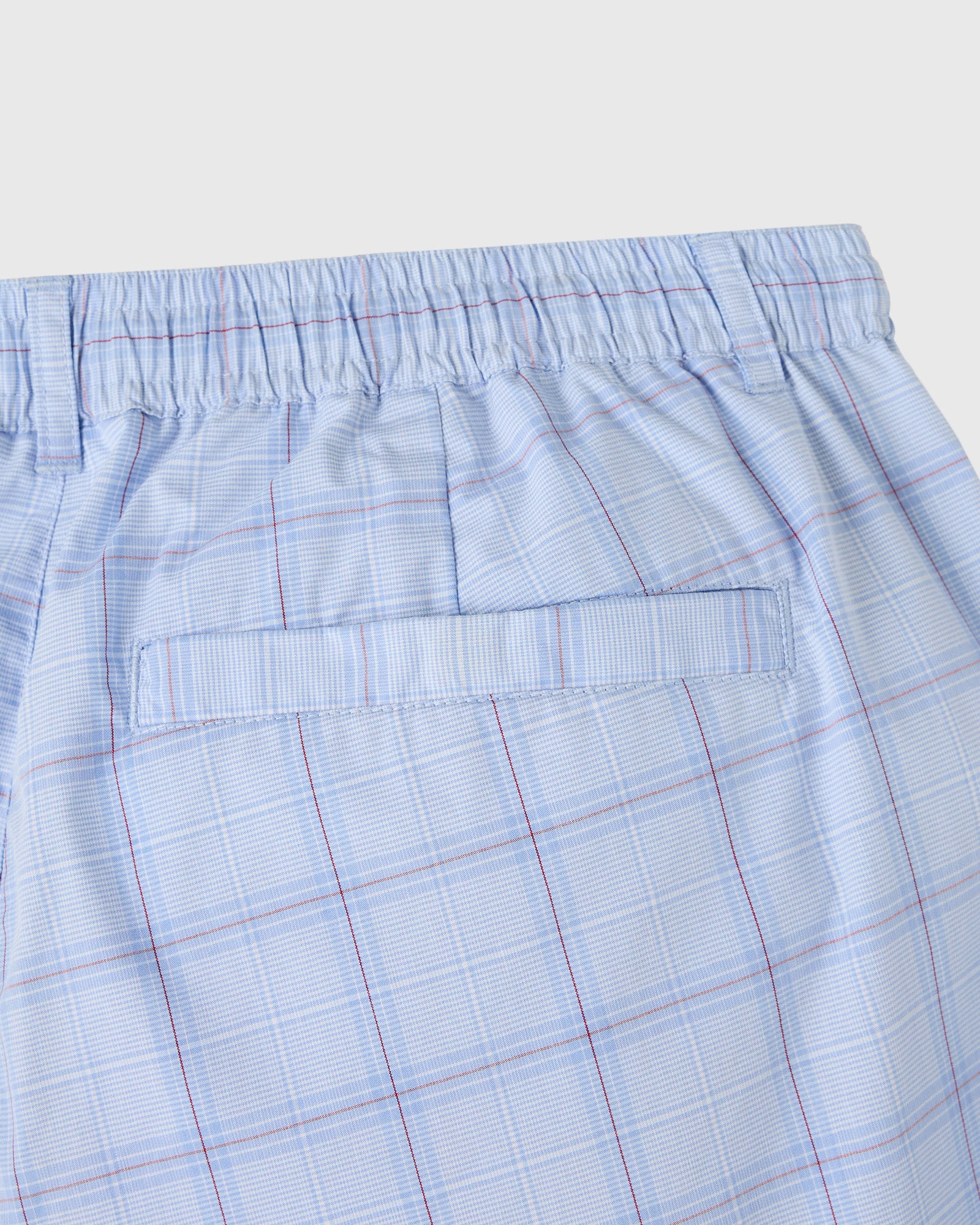Light blue shorts with red and white plaid pattern, elastic waistband, and front pocket detail.