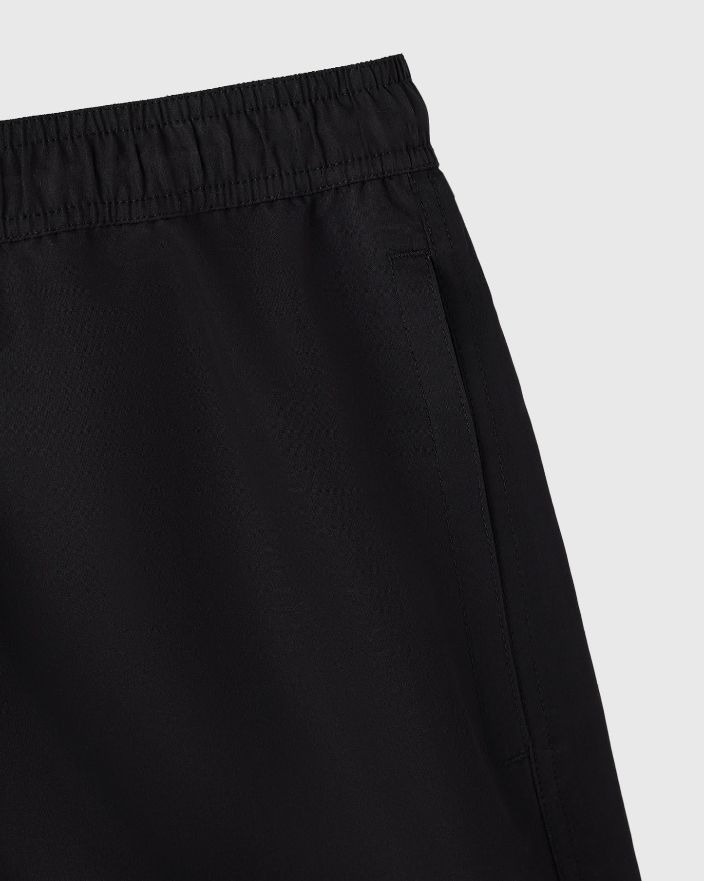 Black swim shorts with elasticated waistband and side seam detail.