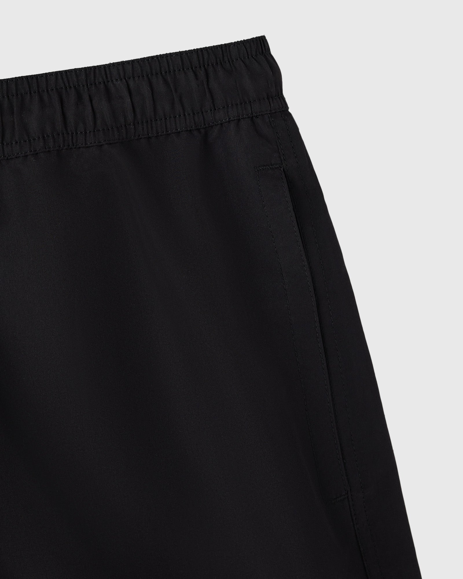 Black swim shorts with elasticated waistband and side seam detail.