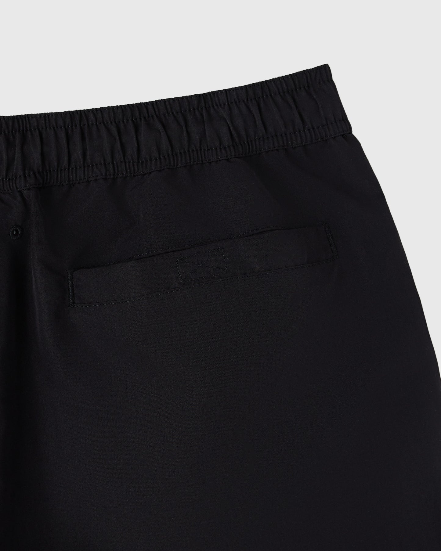 Black swim shorts with elastic waistband and back pocket detail.