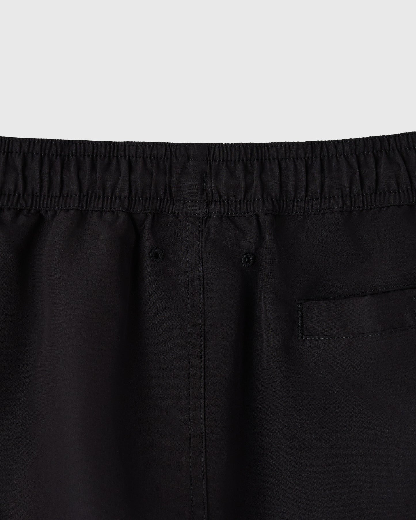 Black swim shorts with elastic waistband and back pocket detail.