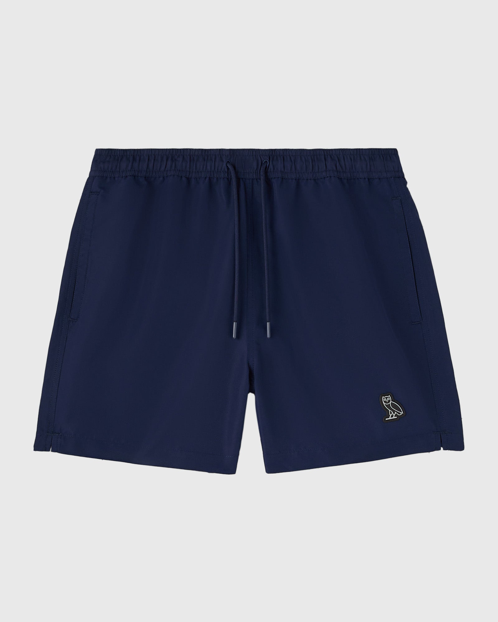 Navy swim shorts with drawstring waist, side pockets, and small embroidered logo on leg.