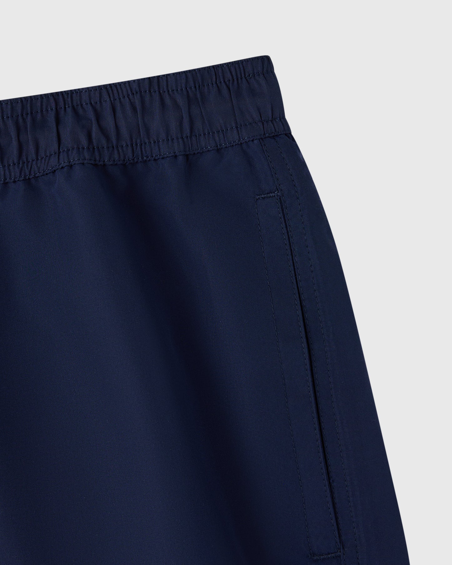 Navy swim short with elastic waistband and side seam detail.