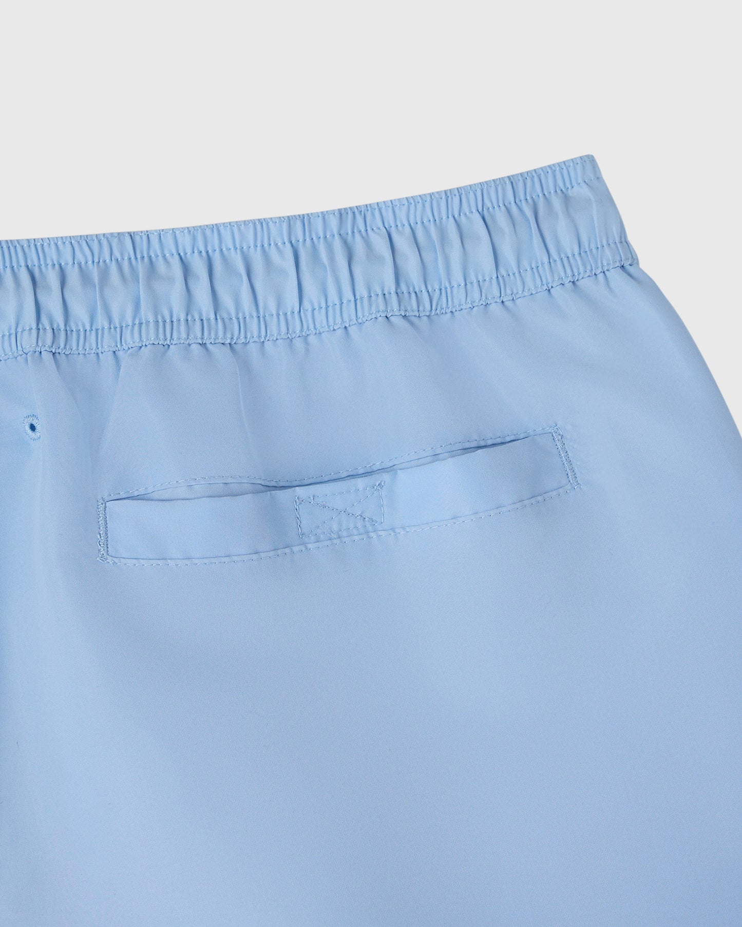 Light blue swim short with elasticated waistband and patch pocket detail.