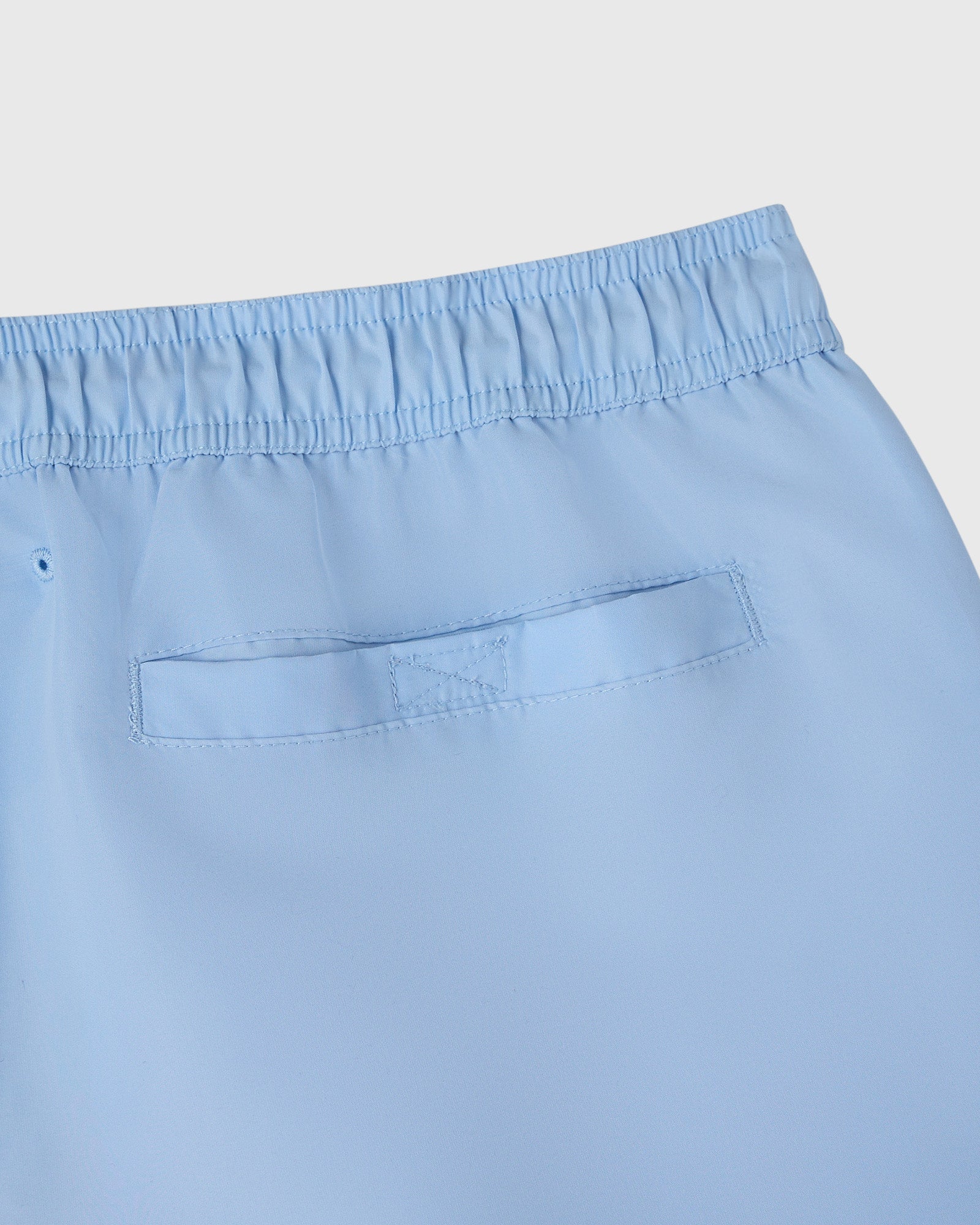Light blue swim short with elasticated waistband and patch pocket detail.