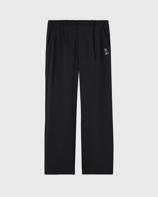 Black stretch nylon chino pants with OVO bird logo on right hip pocket.