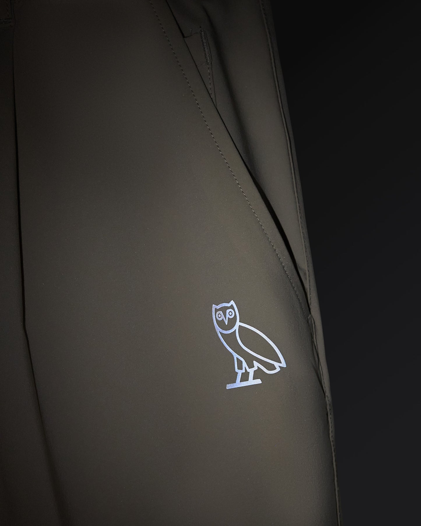 Sandstone-colored stretch nylon chino pants with small owl logo embroidered on thigh.