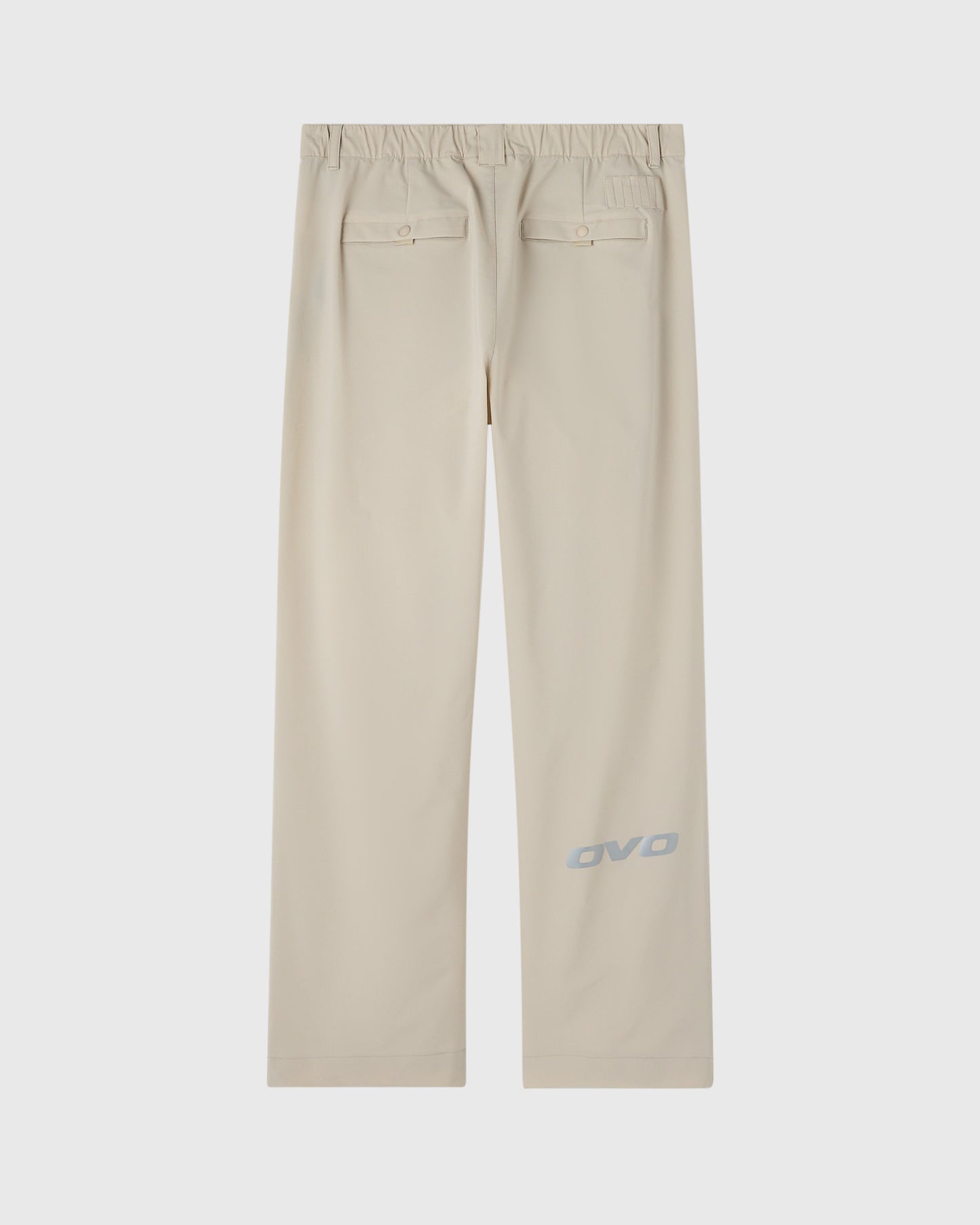 Sandstone chino pants with elastic waistband, back patch pockets, and OVO logo on leg.
