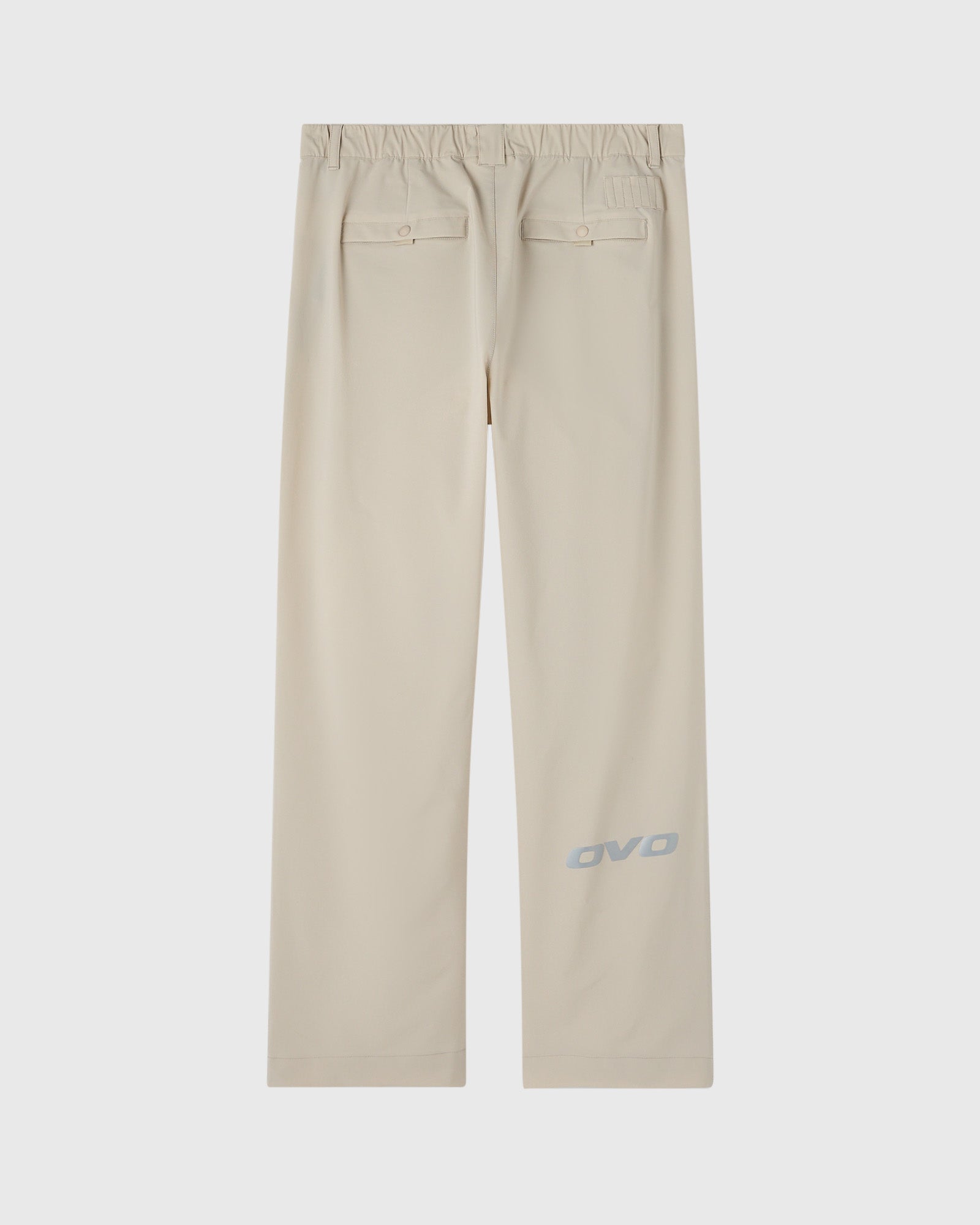 Sandstone chino pants with elastic waistband, back patch pockets, and OVO logo on leg.