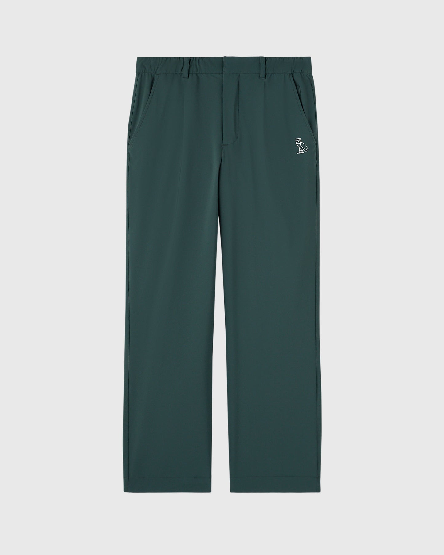 Midnight green chino pants with flat front, side pockets, and small owl logo on thigh.