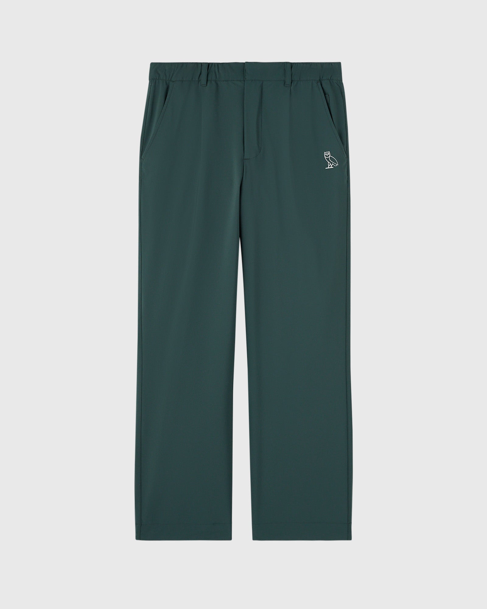 Midnight green chino pants with flat front, side pockets, and small owl logo on thigh.