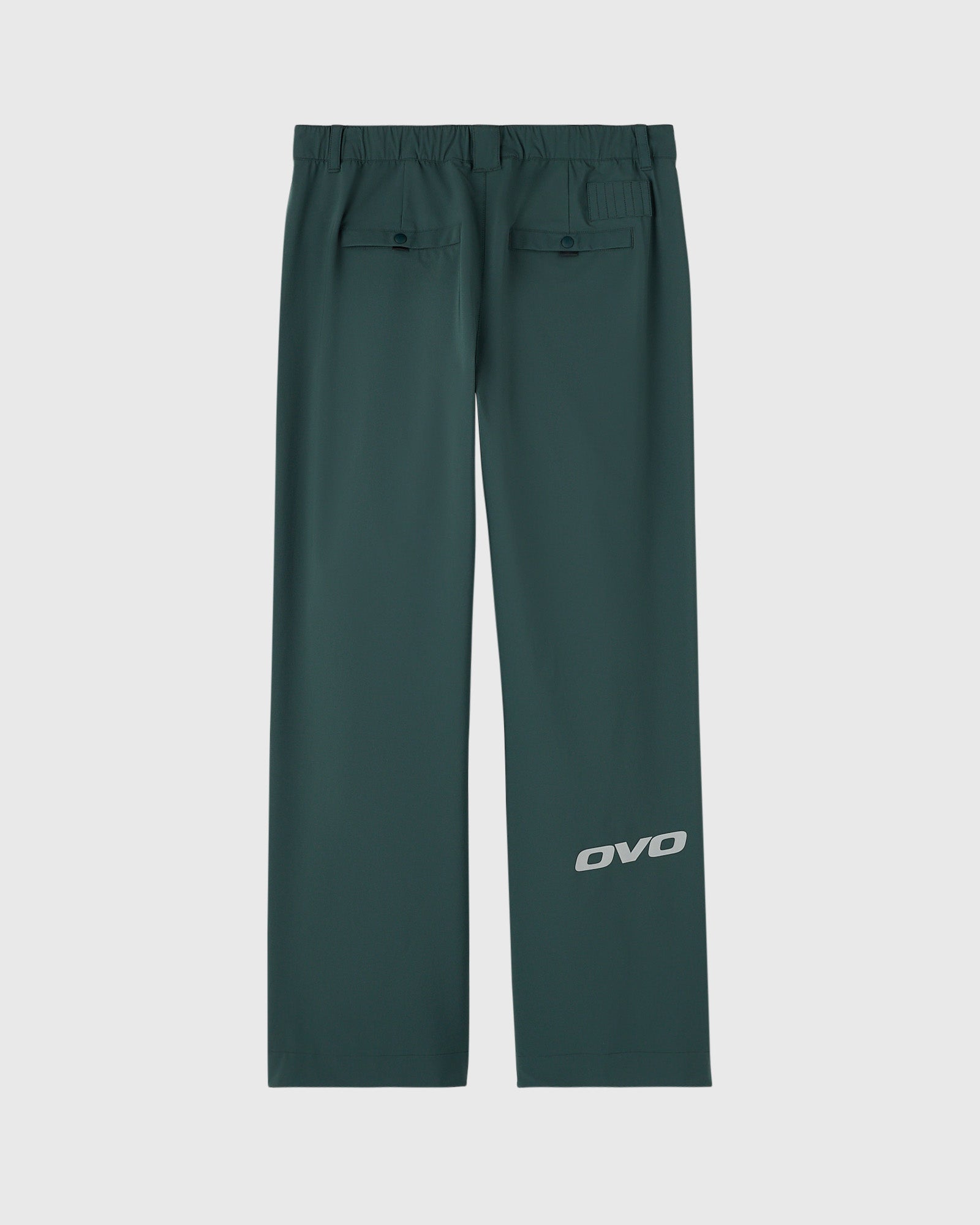 Midnight green chino pants with elastic waistband, flap back pockets, and OVO logo on leg.