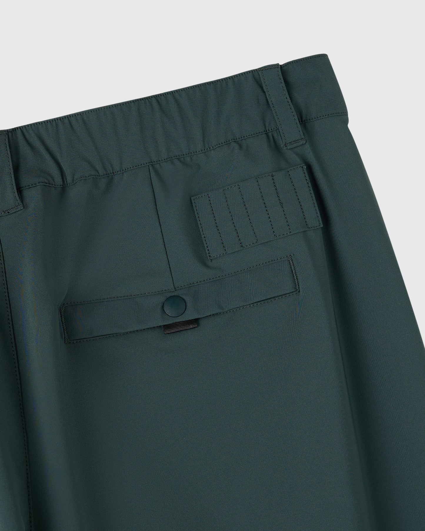Midnight green chino pants with cargo pockets, belt loops, and button closure at the waist.
