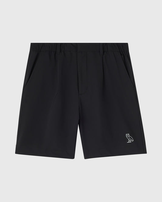 Black stretch nylon golf shorts with OVO owl logo embroidered on right leg.