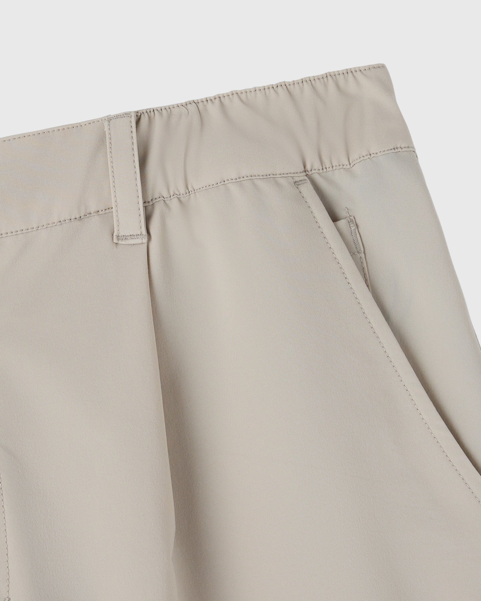 Sandstone golf shorts with flat front, visible waistband, and stitched seams detail.