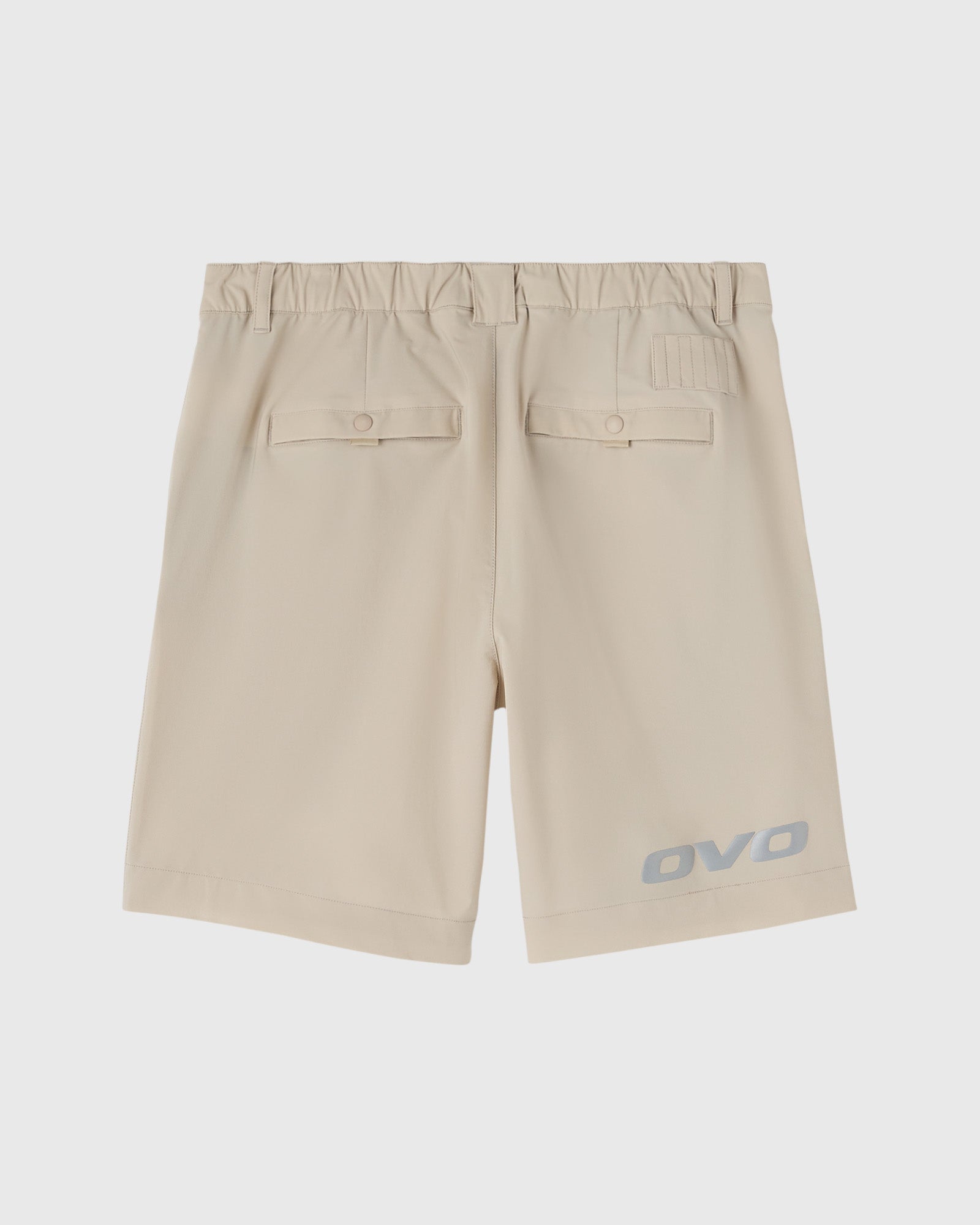 Sandstone golf shorts with elastic waistband, flap pockets, and OVO logo on leg.