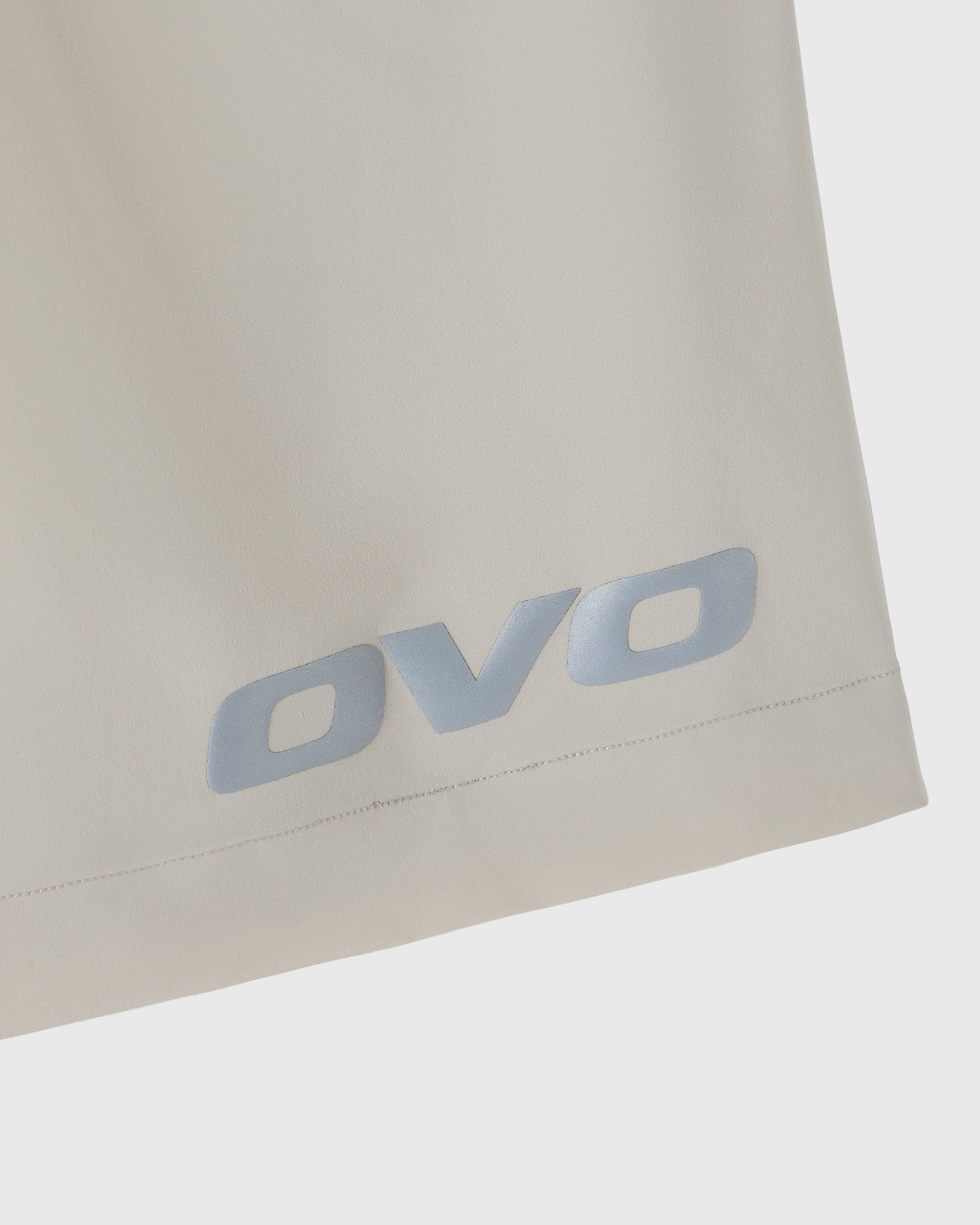 Sandstone-colored golf shorts with OVO logo printed on leg.
