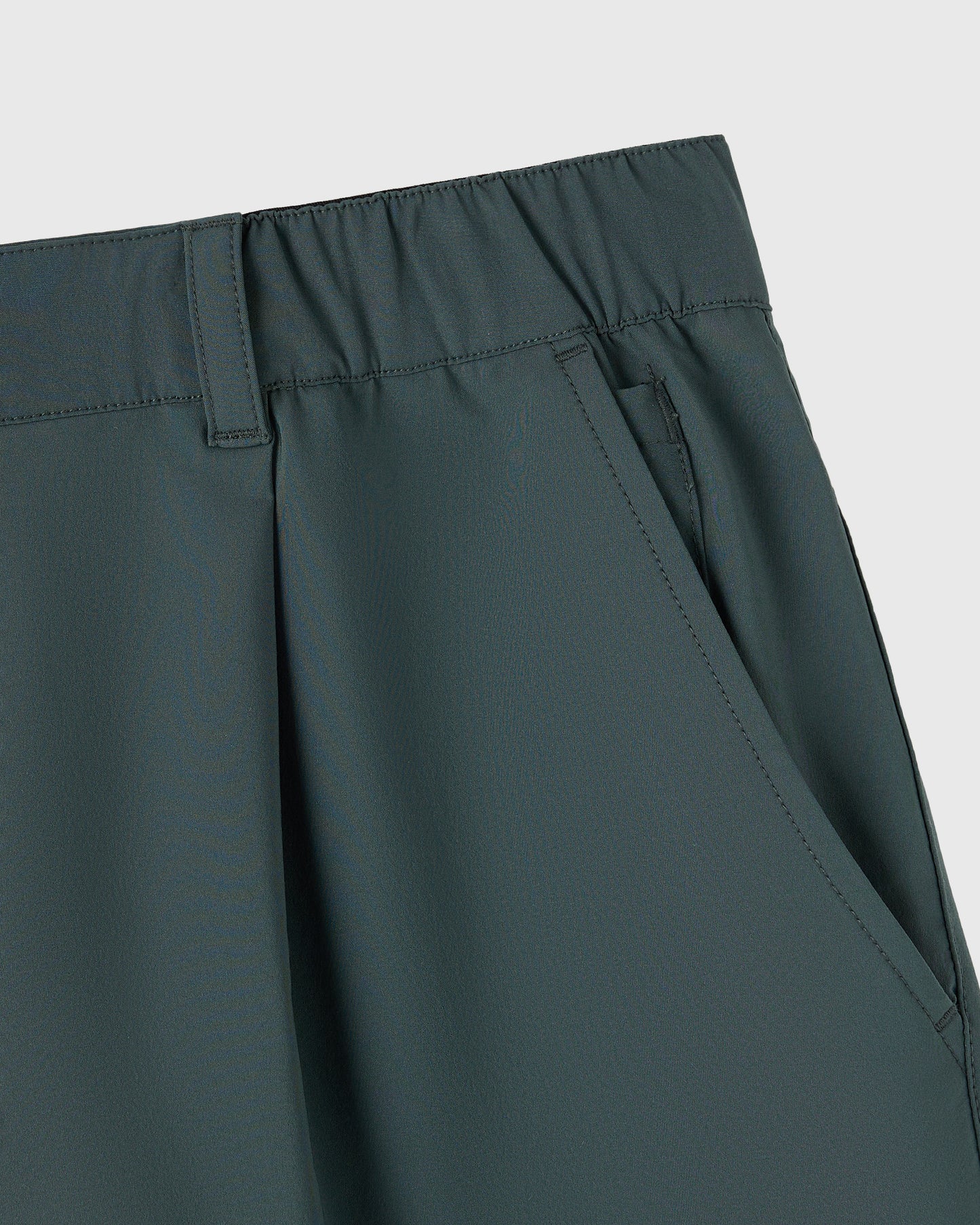 Midnight green stretch nylon golf shorts with flat front waistband and side pockets.
