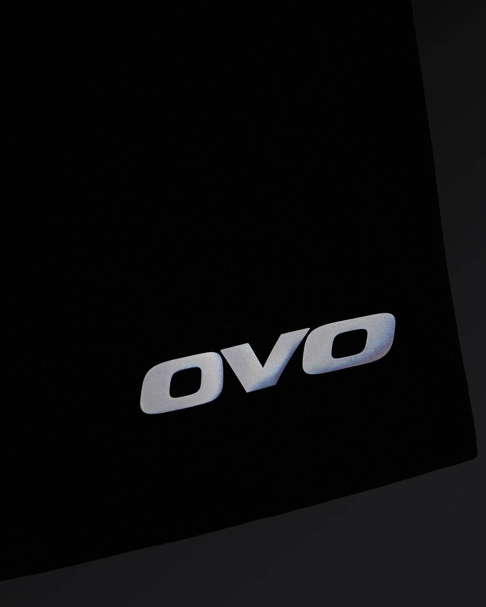 Midnight green golf shorts with OVO logo on thigh and angled seam detail.