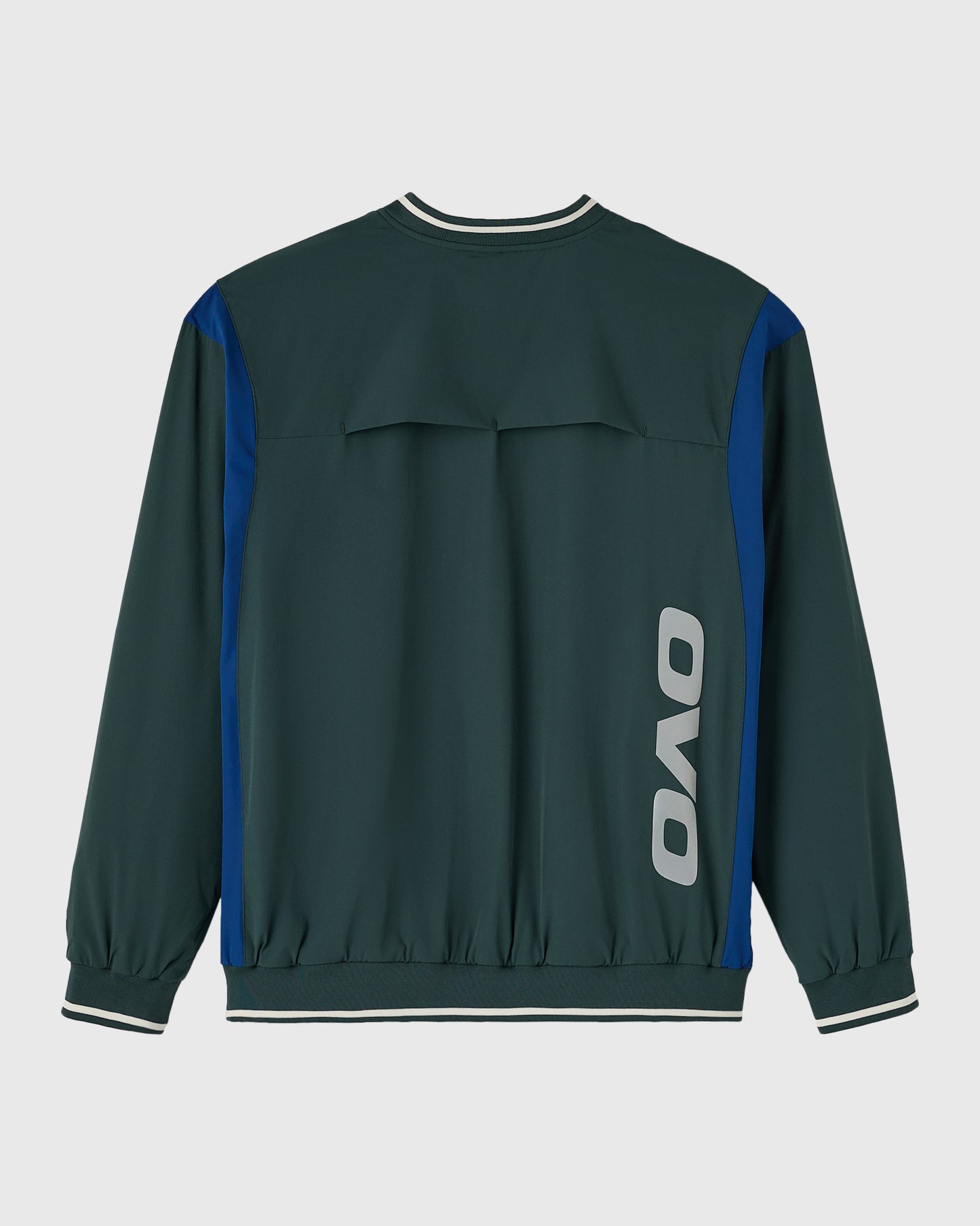 Midnight green pullover with blue side panels, white striping at neckline and cuffs, and OVO logo on back.