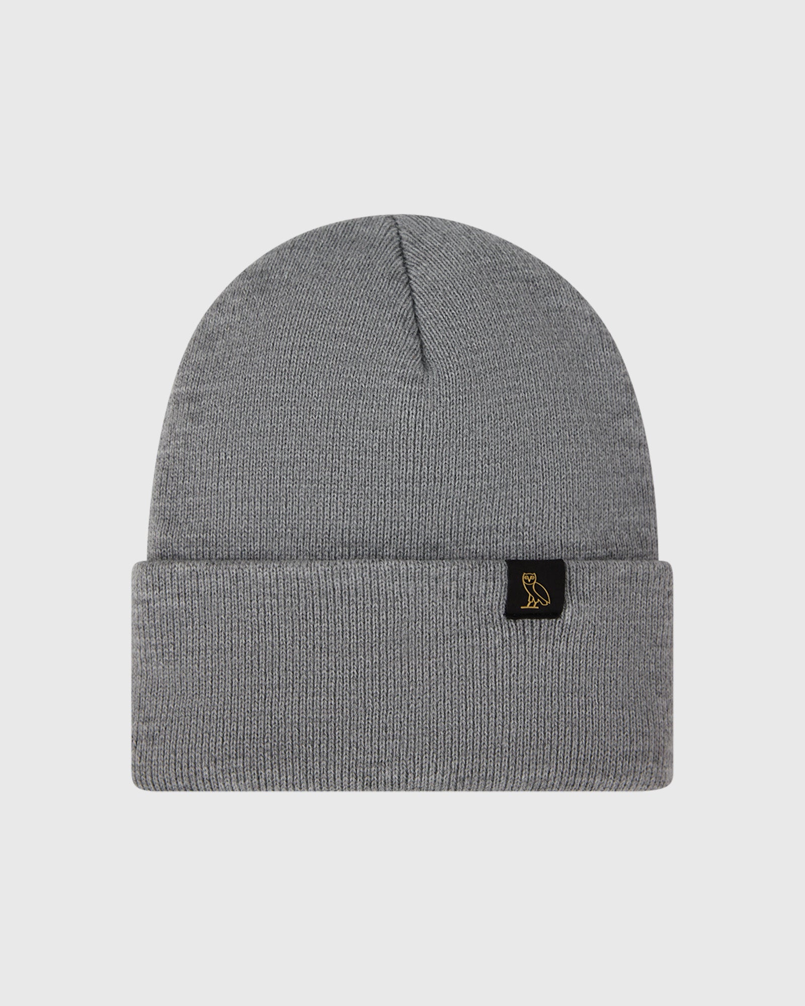 Heather grey ribbed knit beanie with small black label patch featuring gold owl logo.